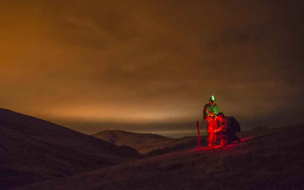 Cpl. Brock O'Shaughnessy and Cpl. James Farran, U.S. Army Reserve Combat Engineer Soldiers with the 374th Engineer Company (Sapper), headquartered in Concord, Calif., find their first point during a night land navigation course through the hills and mountains of Camp San Luis Obispo Military Installation, Calif., July 15, during a two-week field exercise known as a Sapper Leader Course Prerequisite Training. The unit is grading its Soldiers on each event to determine which ones will earn a spot on a 